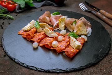 slicing of different meat on black stone