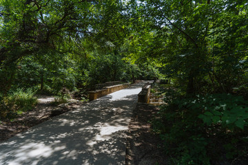 Fototapeta na wymiar Footpath and bridge in texas park sunny day.