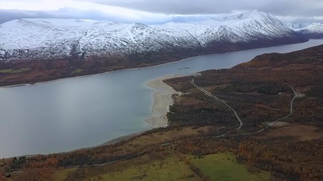 Aerial Descent: Snowy Mountains Over Beautiful Lake in Autumn in Oppdal, Norway