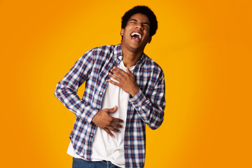 Teenage Guy Laughing Out Loud, Feeling Pain in Belly