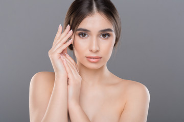 Young woman applying moisturizing cream to her hands skin