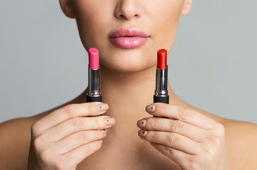 Woman Choosing Between Two Lipstick Colors, Doing Makeup