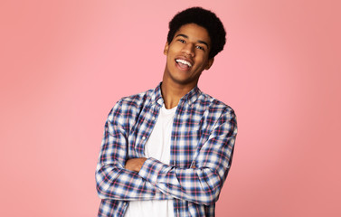 Excited Student Standing with Crossed Arms, Pink Background