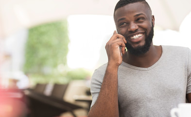 Close up portrait of african american guy talking by phone