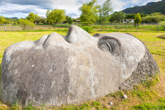 Colombia Tabio face carved in stone in the meadow