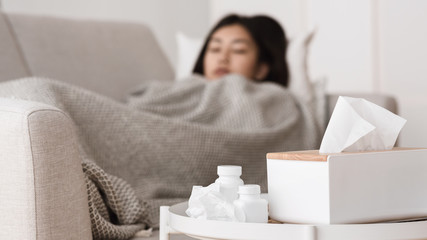 Sick Asian Woman Sleeping with Medicine on Foreground