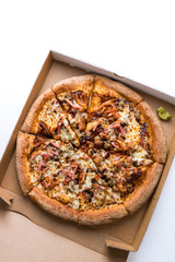 A whole sliced meat barbeque pizza in the delivery box. Top portrait view with copy space.