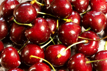 Background texture of fresh red cherry berries. View from above, horizontal, close-up. The concept of healthy nutrition and agriculture.