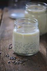 black sesame soy milk in glass on wood