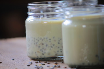 black sesame soy milk in glass on wood