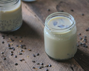 black sesame soy milk in glass on wood