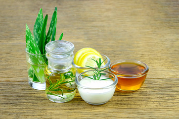 Honey, lemon, rosemary leaves, greek yogurt, aloe vera leaves and essential oil for homeopathy remedy.