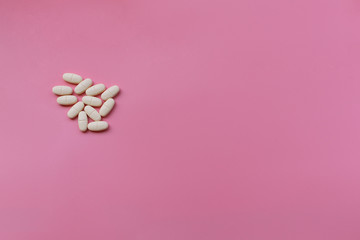 Obraz na płótnie Canvas Top view of a Tablets on a Pink Background