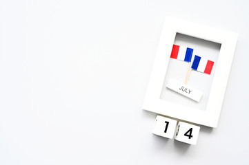 14 july Wooden calendar White background and French flag,Happy Bastille Day. Concept National Day France,Copy space,minimal style