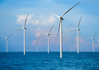 Wind turbine farm power generator in beautiful nature landscape for production of renewable green...