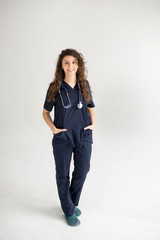 Female Doctor with Hands in Pockets isolated on white background, copy space