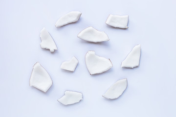 Coconut pieces on white background.