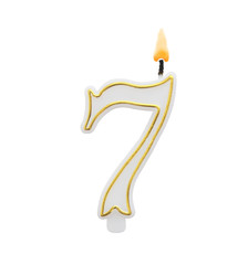 Burning birthday candle isolated on white background, number 7