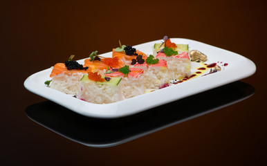 sushi in a plate on a brown background with reflection. fish roll