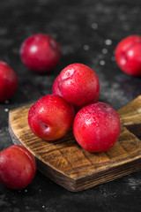 Red plum. Dark background. Healthy diet