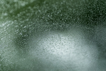 photo graph of glass in soft focus with raindrops