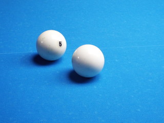 billiard balls on the blue cloth of the billiard table