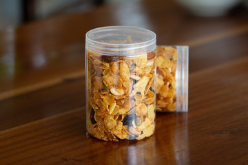 Homemade organic healthy granola with dried fruits in bottles