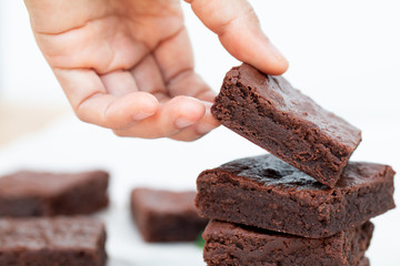 Asian Hand Picking a Chocolate Brownie