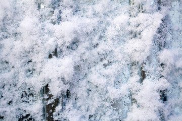 Snow frost on metal. A sheet of metal in the cold was covered with the texture of blue frost.