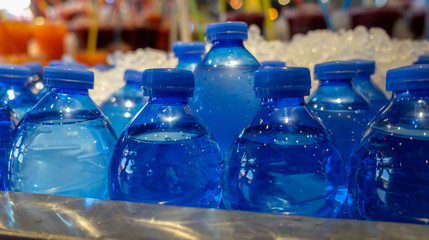 bottled mineral spring water in ice sold at very hot day
