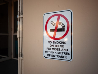 Sign of ' No Smoking on These Premises And Within 4 Metres of Entrance' on wall. Melbourne, VIC Australia.