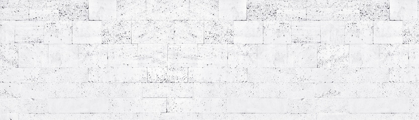 White washed tuff brick wall wide texture. Whitewashed rough stone block masonry panoramic...