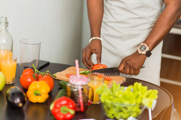 African man preparing healthy food at home in kitchen