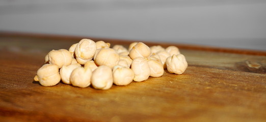 Chickpeas on wooden background close up. Also known as garbanzo beans.   