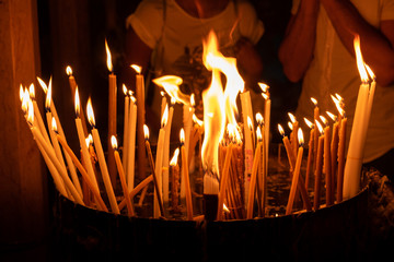Lighted candles at the Holy Sepulchre on Mount Calvary, Jerusalem, Israel