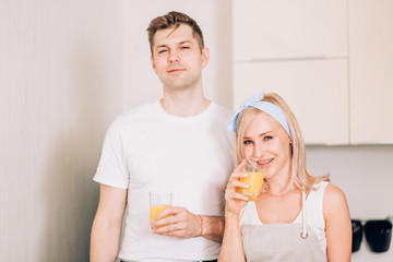 Couple making fresh organic juice in kitchen together