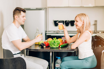 Happy couple eating breakfast together at home