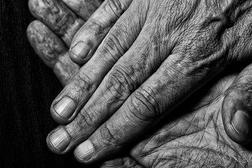 Fototapeta premium Black and White photo of senior man crossed hands detail on dark background