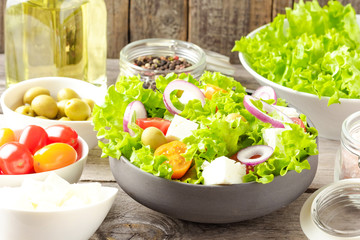 Greek salad with feta on wooden background. Close up