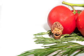 The smiling little man, object of artisanal art, talisman graven from peach pit, happy for a good...