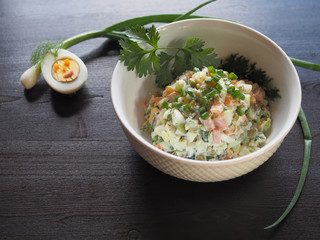 Vegetable salad and half an egg with green onions and herbs. A salad for your child to decorate.