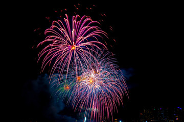 Beautiful colorful fireworks display on the sea beach, Amazing holiday fireworks party or any celebration event in the dark sky.