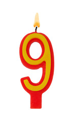 Burning birthday candle isolated on white background, number 9