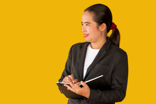 Business Woman Holding Notebook Isolated On Yellow Background.