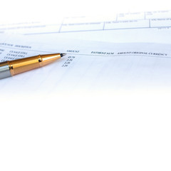 Low angle view of golden pen lying on white sheet of paper in a folder with another set of paperwork