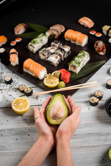 Sushi set with salmon, eel, tuna, avocado, cream cheese Philadelphia, caviar, chuka. Sushi menu. Japanese food on black and white background