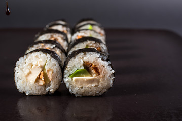 Japanese traditional roll with eel on black background