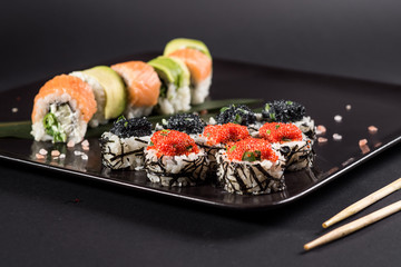 Sushi with caviar on black