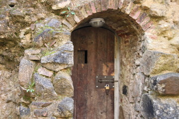 Wooden antiquated door that accesses a medieval tower