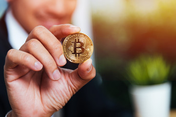 Fototapeta premium Business man hand holding show crypto bitcoin currency money